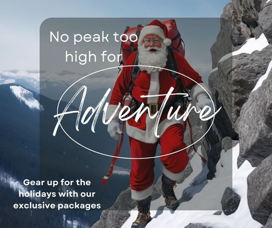 Santa Claus scaling a rocky mountain with gifts in a snowy landscape