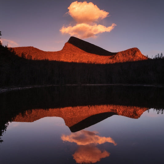 A magical sunset reflecting off the cliffs of Black River Peak, with glowing golden mist